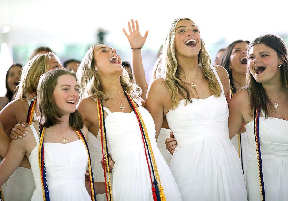 Seniors sing along to "Go Light Your World" at the Notre Dame Academy commencement ceremony in Hingham on Friday, May 20, 2022.