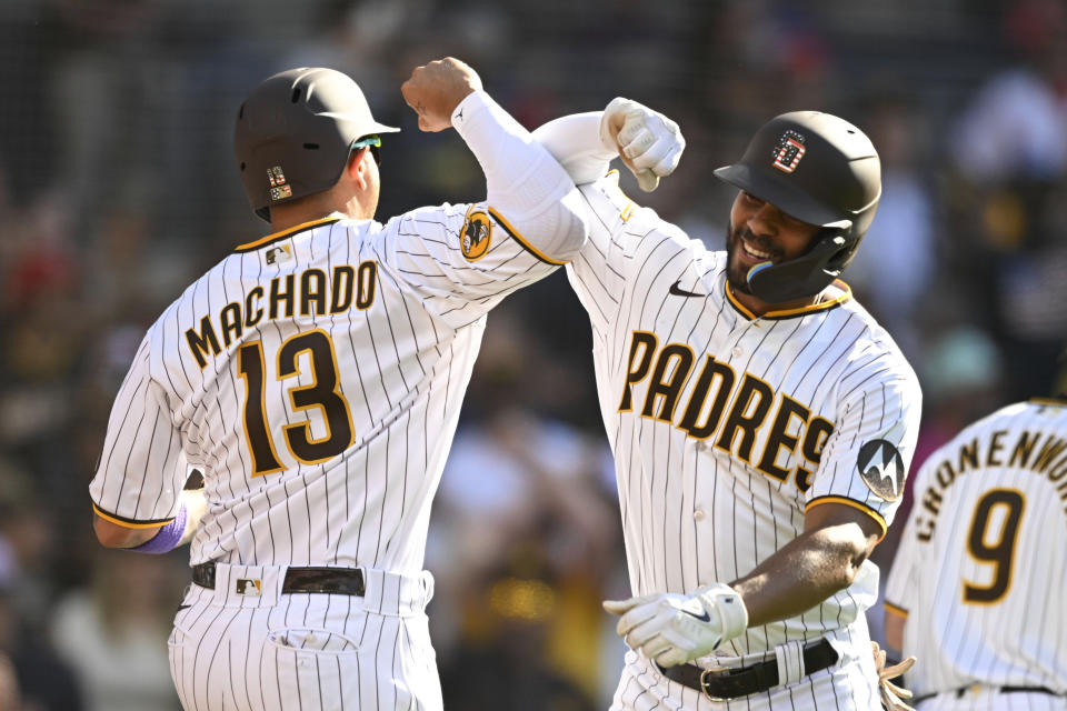 San Diego Padres' Xander Bogaerts, right, is congratulated by Manny Machado (13) after Bogaerts hit a two-run home run against the Los Angeles Angels during the sixth inning of a baseball game Tuesday, July 4, 2023, in San Diego. (AP Photo/Denis Poroy)