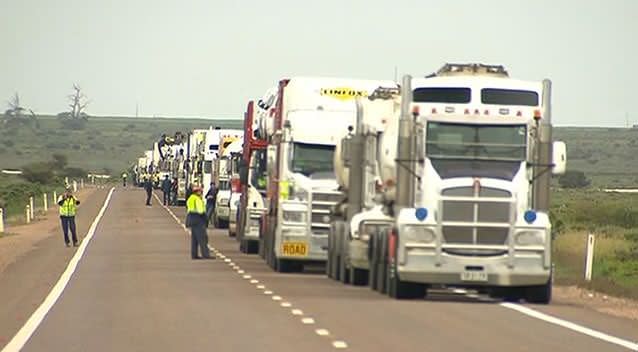 Trucks lined up on the Augusta Highway while the road is blocked following the crash. Photo: 7News.