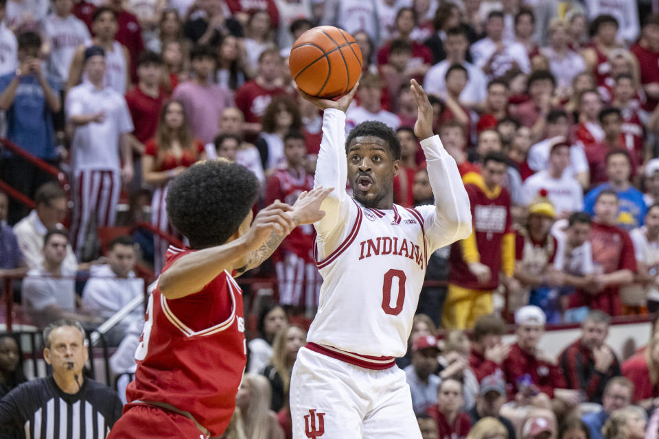 Indiana guard Xavier Johnson (0) shoots while being defended by Wisconsin guard Chucky Hepburn (23) during the second half of an NCAA college basketball game, Tuesday, Feb. 27, 2024, in Bloomington, Ind. (AP Photo/Doug McSchooler)