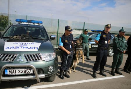 Border police from Romania and Bulgaria stand in front of their vehicles during the official launch of the European Union's Border and Coast Guard Agency at a border crossing on the Bulgarian-Turkish border in Kapitan Andreevo, Bulgaria, October 6, 2016. REUTERS/Stoyan Nenov