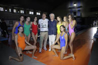 Designer Jean-Charles de Castelbajac, centre left, and Luciano Benetton, centre right, co founder of the Benetton group, pose with models at the conclusion of the Benetton Spring-Summer 2020 collection unveiled during the fashion week, in Milan, Italy, Tuesday, Sept. 17, 2019. (AP Photo/Luca Bruno)