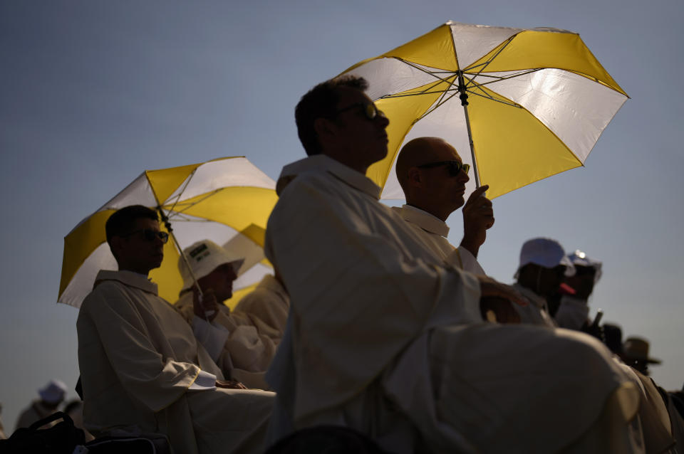 Pilgrims attend a mass presided by the Pope Francis at the Parque Tejo in Lisbon celebrating the 37th World Youth Day on Sunday, Aug. 6, 2023. An estimated 1.5 million young people filled the parque on Saturday for Pope Francis' World Youth Day vigil, braving scorching heat to secure a spot for the evening prayer and to camp out overnight for his final farewell Mass on Sunday morning. (AP Photo/Francisco Seco)