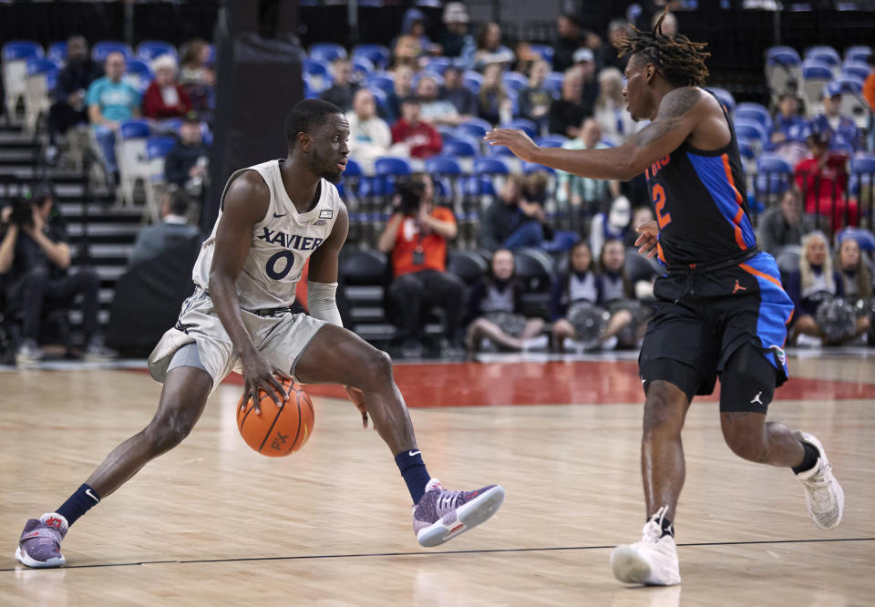 Xavier guard Souley Boum, left, is defended by Florida guard Trey Bonham during the first half of an NCAA college basketball game in the Phil Knight Legacy tournament in Portland, Ore., Thursday, Nov. 24, 2022. (AP Photo/Craig Mitchelldyer)