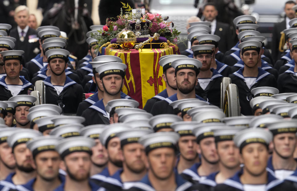 FILE - The coffin of Queen Elizabeth II is carried into Westminster Abbey for her funeral in central London, Sept. 19, 2022. (AP Photo/Bernat Armangue, File)