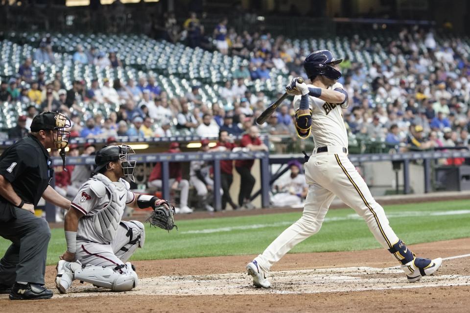 Milwaukee Brewers' Christian Yelich hits an RBI triple during the third inning of a baseball game against the Arizona Diamondbacks Monday, June 19, 2023, in Milwaukee. (AP Photo/Morry Gash)