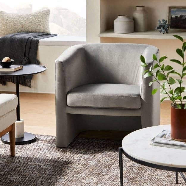 the gray barrel accent chair in a room