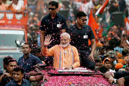 India's Prime Minister Narendra Modi waves towards his supporters during a roadshow in Varanasi, India, April 25, 2019. REUTERS/Adnan Abidi