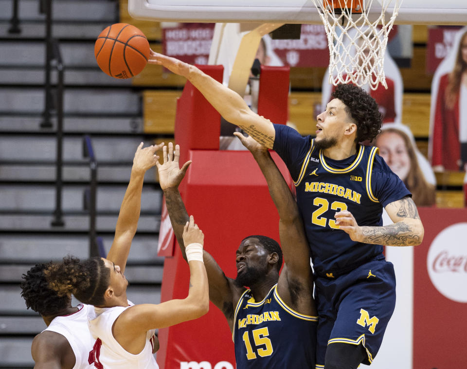 Michigan forward Brandon Johns Jr. (23) blocks a shot by Indiana guard Khristian Lander (4) during the first half of an NCAA college basketball game, Saturday, Feb. 27, 2021, in Bloomington, Ind. (AP Photo/Doug McSchooler)