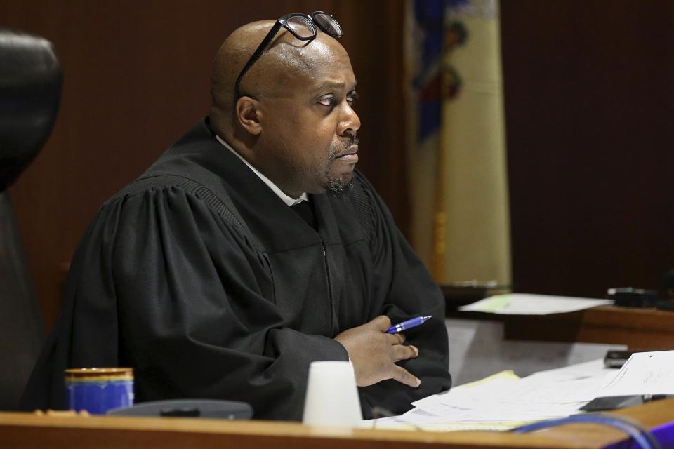 Judge Terrence Cook listens as Mark D'Amico pleads guilty to one count of misappropriating entrusted funds in Burlington County Superior Court in Mount Holly, N.J., on Friday, Dec. 6, 2019. Along with his then-girlfriend, Kate McClure, and a homeless man, Johnny Bobbitt, D'Amico allegedly set up a false online fundraiser and kept the money for themselves. (Tim Tai/The Philadelphia Inquirer via AP)