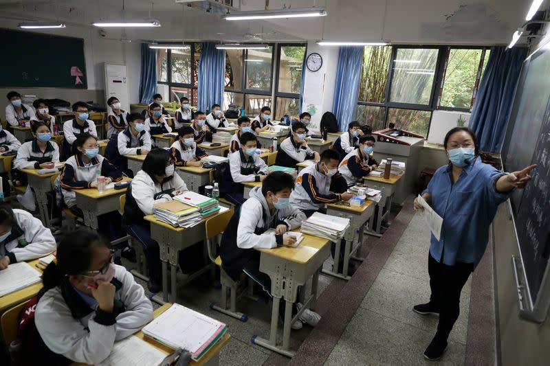 Teacher and senior high school students are seen inside a classroom in Wuhan