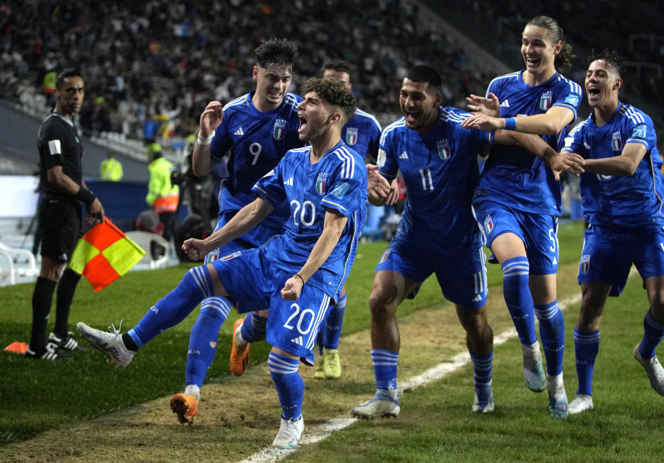 Italy's Simone Pafundi, front, celebrates with teammates after scoring his side's second goal against South Korea during a FIFA U-20 World Cup semifinal soccer match at Diego Maradona stadium in La Plata, Argentina, Thursday, June 8, 2023. (AP Photo/Natacha Pisarenko)