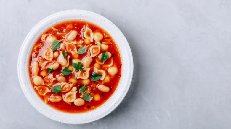 bowl of minestrone soup on gray countertop