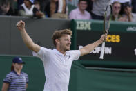 Belgium's David Goffin celebrates defeating Frances Tiafoe of the US in a fourth round men's singles match on day seven of the Wimbledon tennis championships in London, Sunday July 3, 2022. (AP Photo/Alastair Grant)