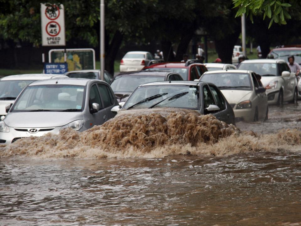 cars driving through flooded street