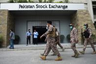 Paramilitary officers inspect the premisses of the Pakistan Stock Exchange building following an attack by gunmen in Karachi on June 29, 2020. - At least six people were killed when gunmen attacked the Pakistan Stock Exchange in Karachi on June 29, with a policeman among the dead after the assailants opened fire and hurled a grenade at the trading floor, police said. (Photo by Rizwan TABASSUM / AFP) (Photo by RIZWAN TABASSUM/AFP via Getty Images)