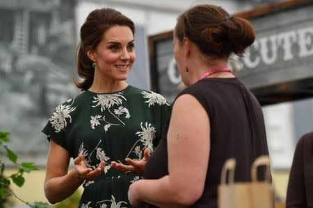 Britain's Catherine, Duchess of Cambridge (L), talks to an exhibitor as she visits the Chelsea Flower Show in London, Britain May 22, 2017.The Chelsea flower show, held annually in the grounds of the Royal Hospital Chelsea, opens to the public this year from May 22. REUTERS/Ben Stansall/Pool
