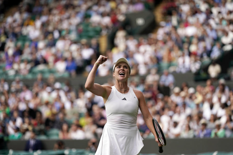 Elina Svitolina celebrates winning the women's singles match against Victoria Azarenka during the Wimbledon tennis championships in London (Alberto Pezzali / AP)