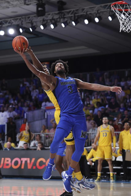 In a photo provided by Bahamas Visual Services, Memphis' Jordan Brown reaches for a rebound next to Michigan's Tarris Reed Jr. during the fourth quarter of an NCAA college basketball game in the Battle 4 Atlantis at Paradise Island, Bahamas, Wednesday, Nov. 22, 2023. (Tim Aylen/Bahamas Visual Services via AP)