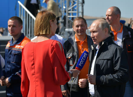 Russian President Vladimir Putin (R) gives an interview as he attends a ceremony opening a bridge, which was constructed to connect the Russian mainland with the Crimean Peninsula across the Kerch Strait, Crimea May 15, 2018. Sputnik/Alexei Druzhinin/Kremlin via REUTERS