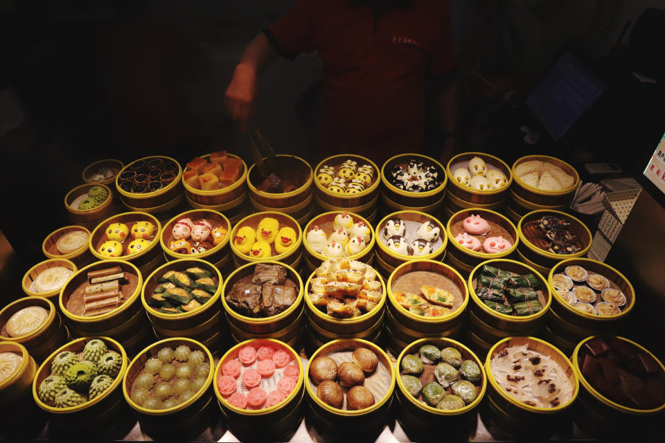 Lots of colorful dim sum at a street market.