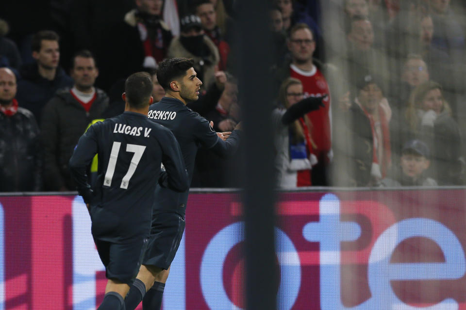 Real midfielder Marco Asensio, right, celebrates after scoring his side's second goal during the first leg, round of sixteen, Champions League soccer match between Ajax and Real Madrid at the Johan Cruyff ArenA in Amsterdam, Netherlands, Wednesday Feb. 13, 2019. (AP Photo/Peter Dejong)