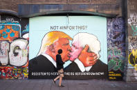 <p>A man passes a mural showing Donald Trump sharing a kiss with former London Mayor Boris Johnson in Bristol, England, May 24, 2016. (Matt Cardy/Getty Images) </p>