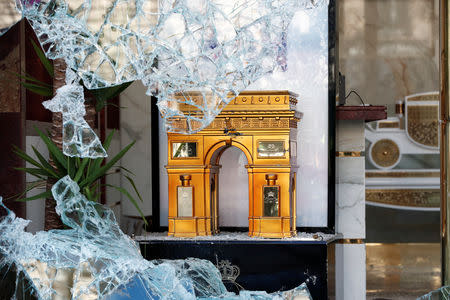 A miniature Arc de Triomphe is seen in a broken store window on the Champs-Elysees during a demonstration by the "yellow vests" movement in Paris, France, March 16, 2019. REUTERS/Benoit Tessier