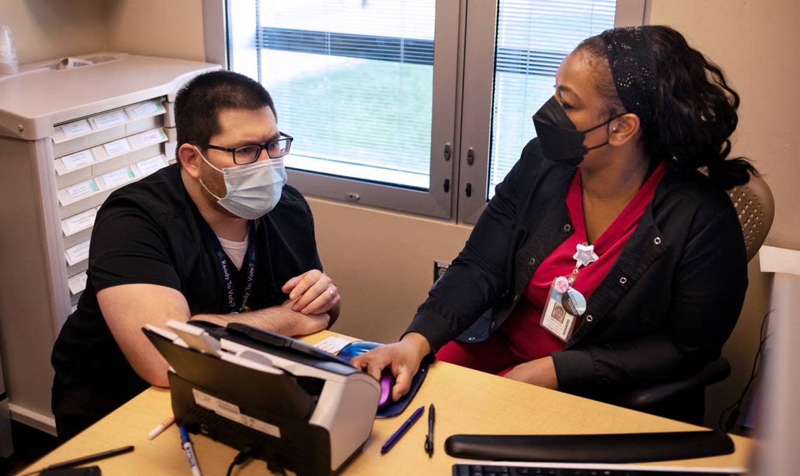 Dr. Michael Baca-Atlas discusses patient care with Crystal Houston, RN, at UNC Wakebrook in Raleigh, Wednesday, March 8. The facility provides care for patients dealing with substance abuse and behavioral issues. He said his patients typically pay more than $100 for a month’s supply of suboxone. Medicaid recipients can buy that same prescription for a copay of $4. “It’s a game changer,” he said.