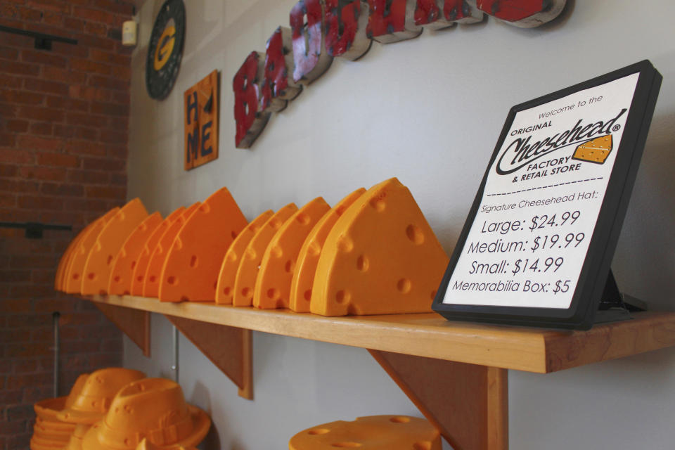 This Jan. 16, 2020 photo shows foam cheesehead hats at Foamation, Inc. in Milwaukee. Ralph Bruno invented the yellow wedge cheesehead in 1987 from his mother's couch stuffing and it has since become popular, particularly for Wisconsin sports fans and residents. His company, Foamation, Inc., moved into a new location in 2016 and soon started tours where people can make their own cheeseheads or other foam products. (AP Photo/Carrie Antlfinger)