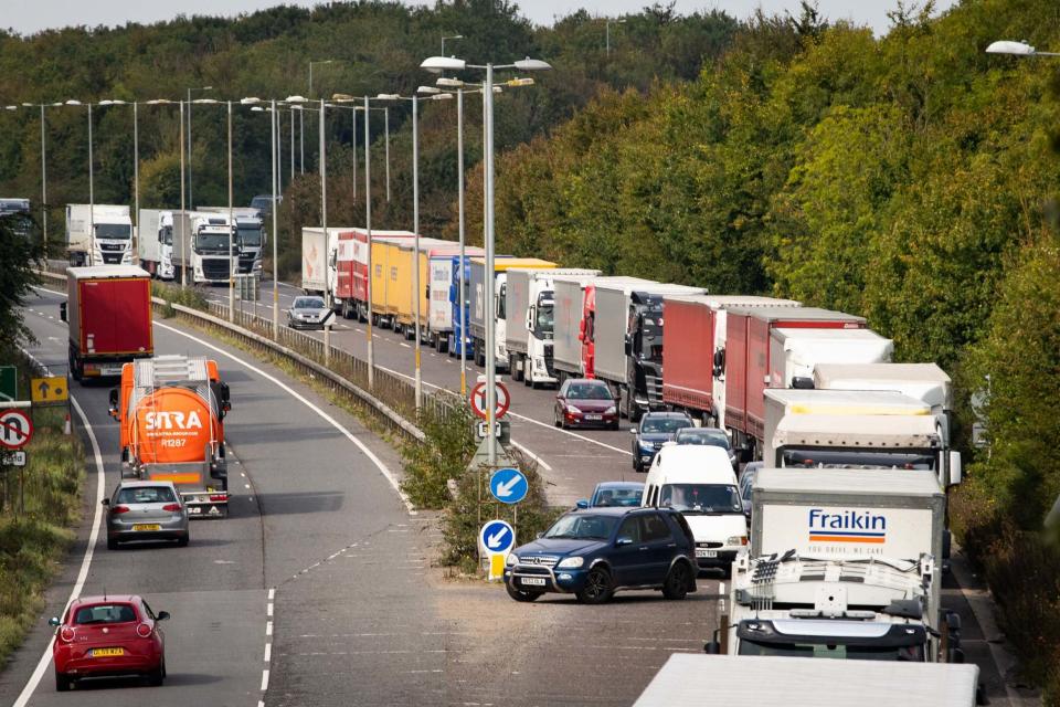 Lorries queue on the A2 near Dover in Kent (PA)