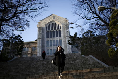 A university student talks on the phone as she leaves at Ewha Woman's University in Seoul, South Korea, November 30, 2015. Picture taken on November 30, 2015. REUTERS/Kim Hong-Ji