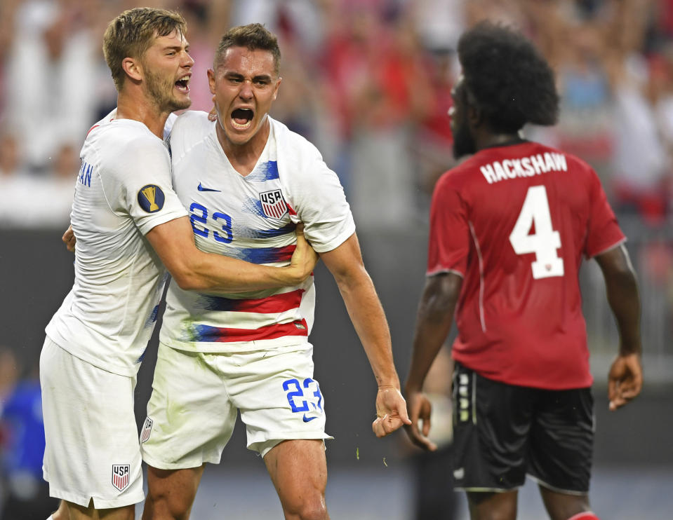 U.S. defender Aaron Long (23) is congratulated by defender Walker Zimmerman after scoring a goal against Trinidad and Tobago during the first half of a CONCACAF Gold Cup soccer match Saturday, June 22, 2019, in Cleveland. (AP Photo/David Dermer)