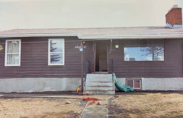 Blood-stained front sidewalk in front of the house in Chipman where two men were shot. (RCMP/Court exhibit - image credit)