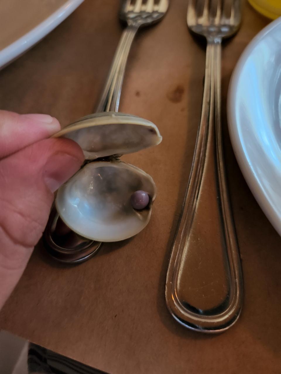 Overland's clam appetizer packed a surprising ingredient: a rare purple pearl. (Photo: Scott Overland)