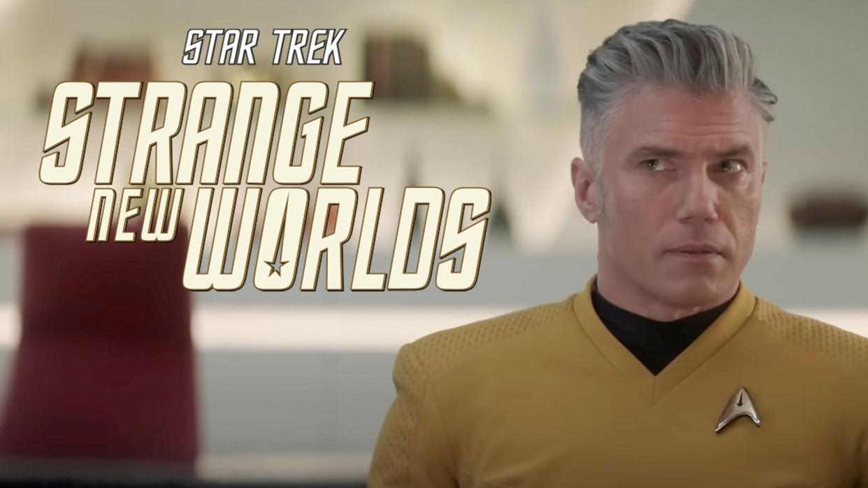  a man with gray hair in a yellow starfleet uniform 