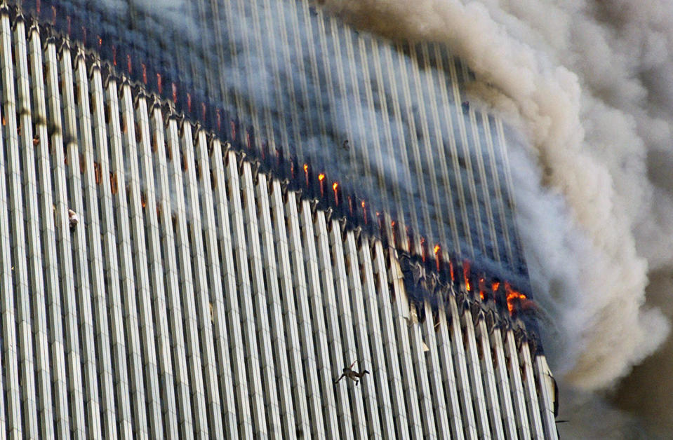 <p>A person falls from the north tower of New York's World Trade Center as another clings to the outside, left, while smoke and fire billow from the building, Tuesday Sept. 11, 2001. (AP Photo/Richard Drew)</p> 