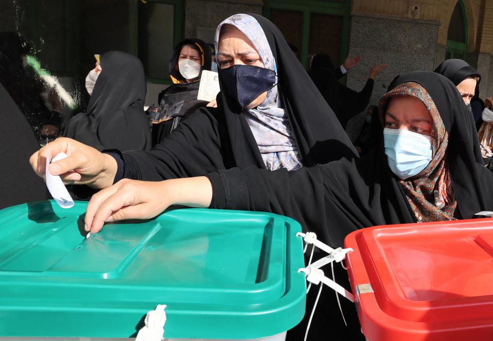 Iranian women cast their ballots for presidential election at a polling station in Tehran (AFP via Getty Images)