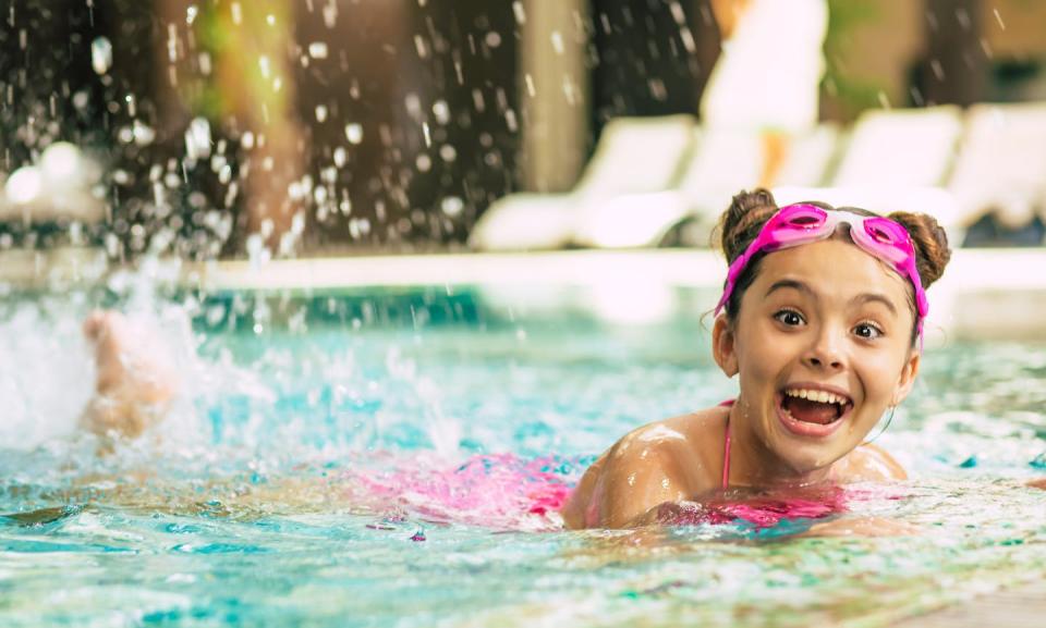 It’s tempting for adults to watch kids splash from the poolside, but research shows it’s worth jumping in alongside them. <a href="https://www.gettyimages.com/detail/photo/happy-beautiful-little-smiling-girl-in-goggles-and-royalty-free-image/1263550322?adppopup=true" rel="nofollow noopener" target="_blank" data-ylk="slk:Povozniuk/iStock via Getty Images Plus;elm:context_link;itc:0;sec:content-canvas" class="link ">Povozniuk/iStock via Getty Images Plus</a>