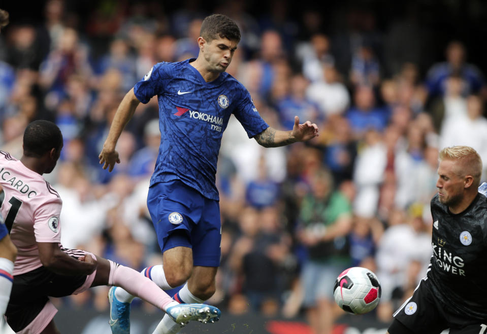 FILE - In this Sunday, Aug. 18, 2019 file photo, Chelsea's Christian Pulisic, center, vies for the ball with Leicester's Ricardo Pereira, left, in front of Leicester's goalkeeper Kasper Schmeichel, right, during the English Premier League soccer match between Chelsea and Leicester City at Stamford Bridge stadium in London. U.S. winger, Christian Pulisic, who completed his move to Stamford Bridge in the offseason for $73 million, hasn’t played a minute of Chelsea’s last three Premier League matches and also stayed on the bench during the team’s 1-0 home loss to Valencia in the Champions League two weeks ago. (AP Photo/Frank Augstein, File)