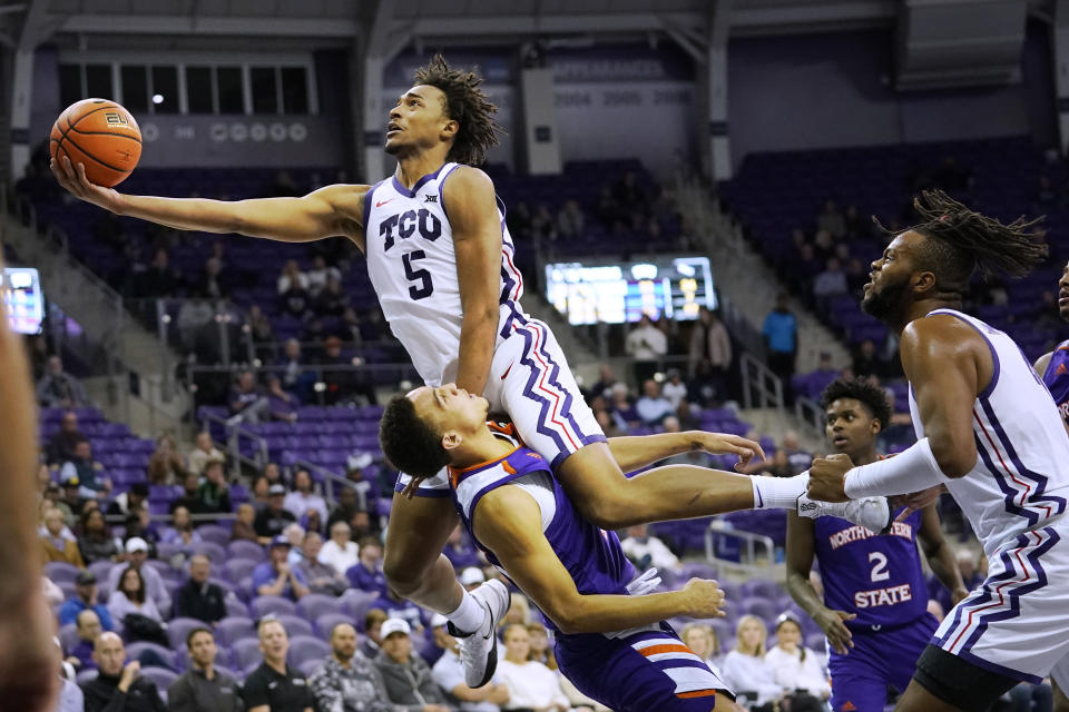 TCU forward Chuck O'Bannon Jr. (5) tries to score over Northwestern State forward Dayne Prim during the second half of an NCAA college basketball game in Fort Worth, Texas, Monday, Nov. 14, 2022. Northwestern State won 64-63. (AP Photo/LM Otero)