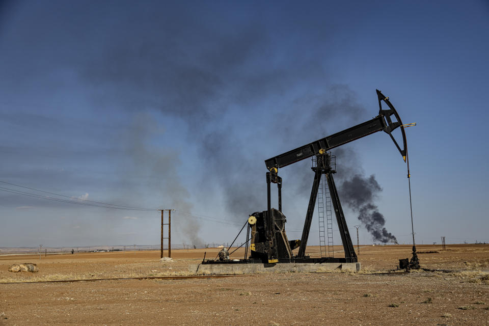 A smoke rises from an oil depot struck by Turkish air force near the town of Qamishli, Syria, Wednesday, Nov. 23, 2022. Turkey's president says he will carry out a land invasion into Kurdish areas of northern Syria. Recep Tayyip Erdogan's statement in Ankara Wednesday came after Turkey carried out a barrage of airstrikes on suspected Kurdish militants in northern Syria and Iraq in recent days. (AP Photo/Baderkhan Ahmad)