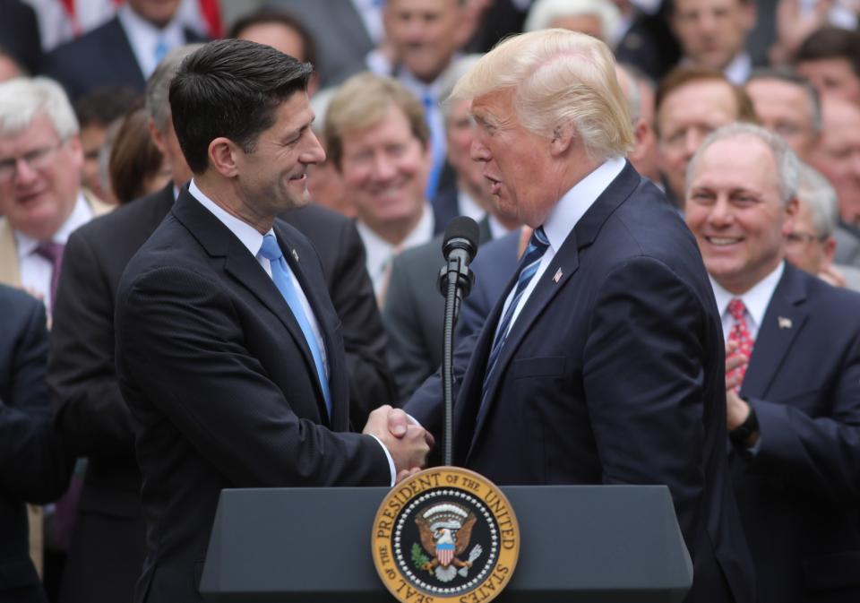 U.S. Speaker of the House Paul Ryan and President Donald Trump shake hands.