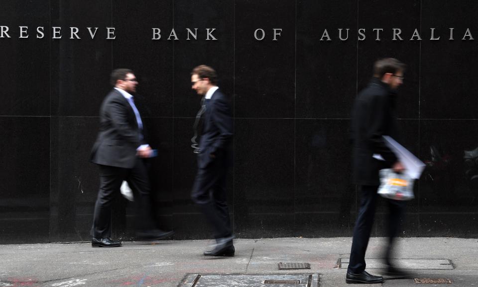 Office employees walk in front of the Reserve Bank of Australia in Sydney on September 4, 2018. - Weak inflation, sluggish wage growth and high levels of household debt saw Australia's central bank keep interest rates on hold at a record low on September 4. (Photo by Saeed KHAN / AFP)        (Photo credit should read SAEED KHAN/AFP/Getty Images)