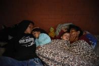 <p>Honduran migrants sleep at a community gymnasium in Chiquimula, Guatemala, on on Oct. 17, 2018. (Photo: Orlando Estrada/AFP/Getty Images) </p>