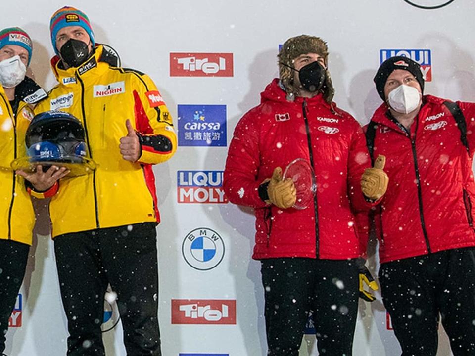 Justin Kripps, far right, and Cam Stones, second from far right, stopped the clock in one minute 43.96 seconds to finish 48-100ths behind reigning Olympic bobsleight champions Francesco Friedrich and Thorsten Margis of Germany, left, for second place at a World Cup event on Saturday in Innsbruck, Austria. (Twitter/@IBSFsliding - image credit)