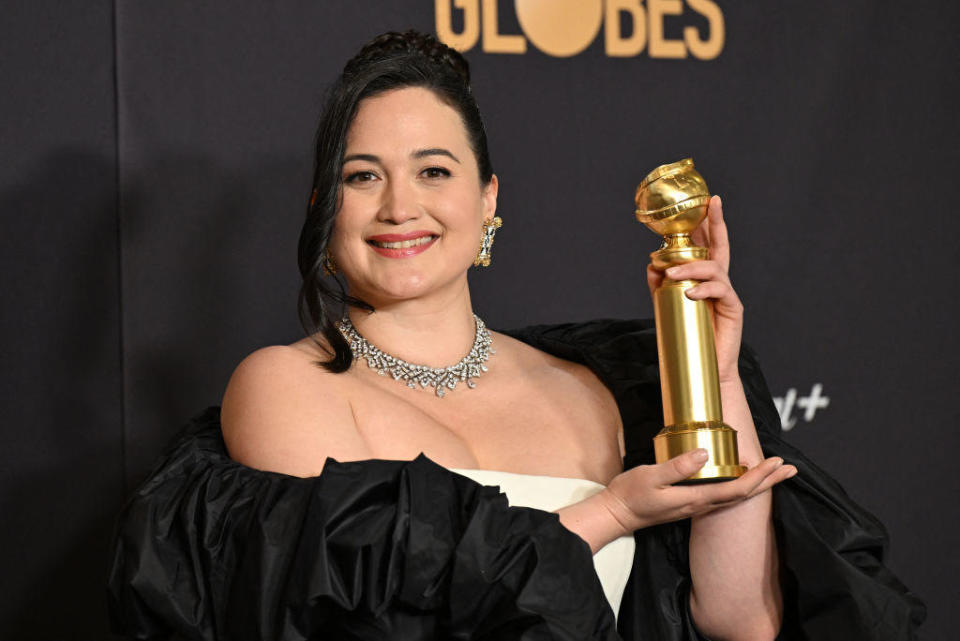 Lily Gladstone poses with her Golden Globe award for Best Performance by a Female Actor in a Motion Picture - Drama, for 