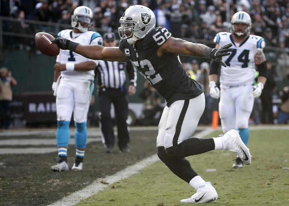 FILE - In this Nov. 27, 2016, file photo, Oakland Raiders defensive end Khalil Mack (52) scores a touchdown after intercepting a pass from Carolina Panthers quarterback Cam Newton (1) during the first half of an NFL football game in Oakland, Calif. The Chicago Bears have acquired star pass rusher Khalil Mack from the Raiders on Saturday, Sept. 1, 2018, in a massive trade that sends two first-round draft picks to Oakland. A person with direct knowledge of the trade told The Associated Press that Oakland will get first-round selections in 2019 and 2020, a sixth-rounder next year and a third-rounder in 2020. Oakland also included its second-round selection in 2020. The person spoke on condition of anonymity because the trade had not been announced. (AP Photo/Tony Avelar, File)