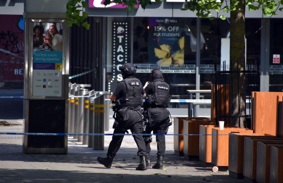 Armed police walk along Milton Street in Nottingham, as three people have been found dead in the city in what police described as a 