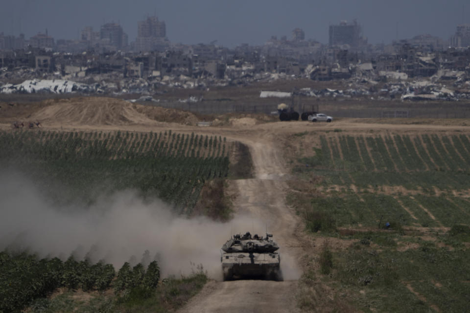 Israeli soldiers move on the top of a tank near the Israeli-Gaza border, as seen from southern Israel, Thursday, May 16, 2024. (AP Photo/Leo Correa)